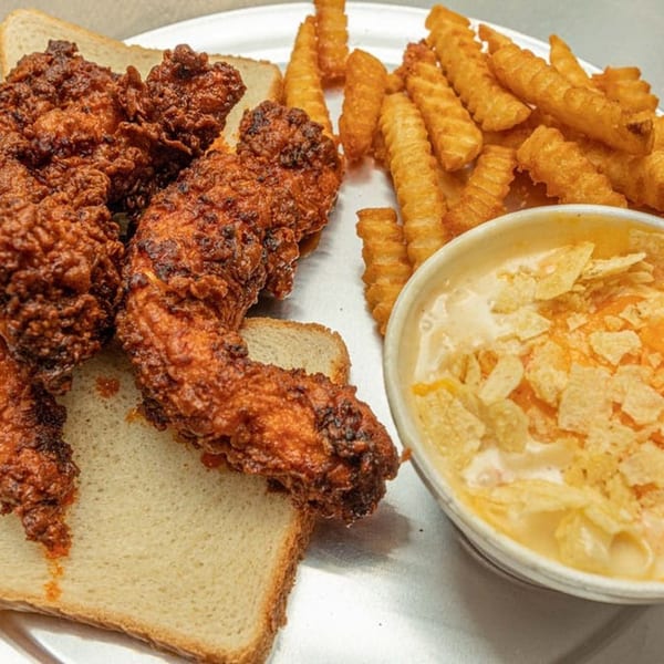 Maddie G's fried chicken tenders on white bread, crinkle-cut fries, and mac and cheese.